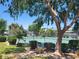 Tennis court with green surface, framed by lush trees, ideal for community recreation at 745 Greenbriar Townhouse Way, Las Vegas, NV 89121