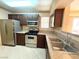 Well-lit kitchen featuring stainless steel appliances, dark cabinets, and stone countertops at 8101 W Flamingo Rd # 1044, Las Vegas, NV 89147