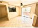Inviting living room with a ceiling fan, tan tile floors, slider to a patio, and open access to the kitchen at 8101 W Flamingo Rd # 1044, Las Vegas, NV 89147