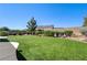Lush backyard features artificial turf surrounded by desert landscaping for easy maintenance at 8204 Turbys Treehouse Pl, Las Vegas, NV 89131