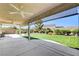 Backyard featuring lush artificial turf, a spacious covered patio, and mature landscaping at 8204 Turbys Treehouse Pl, Las Vegas, NV 89131