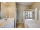 Bathroom featuring a tub, a separate glass-enclosed shower, and a single sink at 8204 Turbys Treehouse Pl, Las Vegas, NV 89131