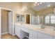 Ensuite bathroom featuring double sinks with a vanity, soaking tub, and stand-up shower at 8204 Turbys Treehouse Pl, Las Vegas, NV 89131