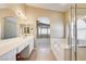 Spacious ensuite bathroom with a double sink vanity, soaking tub, and stand-up shower at 8204 Turbys Treehouse Pl, Las Vegas, NV 89131