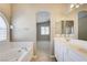 A luxurious bathtub with a walk-in shower is visible from the double vanity, which has plenty of storage at 8204 Turbys Treehouse Pl, Las Vegas, NV 89131