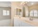 The double vanity with large mirrors is connected to the main bedroom through an archway at 8204 Turbys Treehouse Pl, Las Vegas, NV 89131