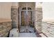 Close-up of an ornate metal entry gate featuring stone columns and decorative metal scrollwork at 8204 Turbys Treehouse Pl, Las Vegas, NV 89131