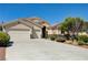 Well-maintained single-story house with manicured landscaping, a three-car garage and decorative stone accents at 8204 Turbys Treehouse Pl, Las Vegas, NV 89131