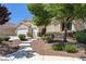 Beautiful single-story house featuring decorative stone accents, a two-car garage and a well-manicured lawn at 8204 Turbys Treehouse Pl, Las Vegas, NV 89131