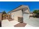 Side view of a tan single-story home with a tiled roof and a two-car garage on the side at 8204 Turbys Treehouse Pl, Las Vegas, NV 89131