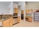 Kitchen featuring stainless steel dishwasher, granite countertops, and view to laundry room at 8204 Turbys Treehouse Pl, Las Vegas, NV 89131