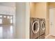 Convenient laundry room featuring modern side-by-side washer and dryer, with access to the main living area at 8204 Turbys Treehouse Pl, Las Vegas, NV 89131