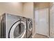 Laundry room showcases modern appliances and convenient access to the exterior door at 8204 Turbys Treehouse Pl, Las Vegas, NV 89131
