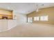 Spacious living room with carpet floors, neutral walls, and abundant natural light at 8204 Turbys Treehouse Pl, Las Vegas, NV 89131