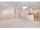 Spacious living room with carpet floors, neutral walls, open floor plan to kitchen at 8204 Turbys Treehouse Pl, Las Vegas, NV 89131