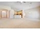 Spacious living room with carpet floors, neutral walls, open floor plan to kitchen at 8204 Turbys Treehouse Pl, Las Vegas, NV 89131
