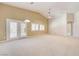 Spacious living room with carpet floors, neutral walls, with natural lighting at 8204 Turbys Treehouse Pl, Las Vegas, NV 89131
