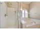 Walk-in shower and bathtub combination are next to an arched window that has plantation shutters for added privacy at 8204 Turbys Treehouse Pl, Las Vegas, NV 89131