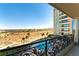 Balcony view featuring a pool, lounge area, and landscaping; with palm trees and city landscape in the distance at 9101 Alta Dr # 301, Las Vegas, NV 89145