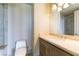 A bathroom featuring a toilet and vanity with a sink and wooden cabinets for storage at 9101 Alta Dr # 301, Las Vegas, NV 89145