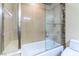 Bathroom features a tub, glass door, shower, toilet, and tile surround at 9101 Alta Dr # 301, Las Vegas, NV 89145