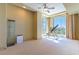 Bright bedroom with carpeted floor, fan, and views of the city at 9101 Alta Dr # 301, Las Vegas, NV 89145