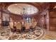 The elegant dining room features wood paneled walls, a fireplace, and gorgeous flooring at 9101 Alta Dr # 301, Las Vegas, NV 89145