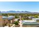 Luxurious entrance and grounds with mountain views, featuring a circular driveway and beautifully landscaped surroundings at 9101 Alta Dr # 301, Las Vegas, NV 89145