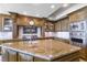 Chef's kitchen boasting custom cabinetry, a large granite island, and stainless steel appliances at 9101 Alta Dr # 301, Las Vegas, NV 89145