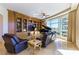 Elegant living room showcasing custom wood built-ins, plush seating, grand piano, and a wall of windows with scenic views at 9101 Alta Dr # 301, Las Vegas, NV 89145