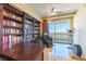 Office space featuring custom built-in shelving, desk, and private balcony with city views at 9101 Alta Dr # 301, Las Vegas, NV 89145