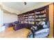 Well-appointed home office with extensive built-in bookshelves and comfortable seating at 9101 Alta Dr # 301, Las Vegas, NV 89145