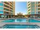 A lavish community pool with plenty of seating between high rise towers and mature landscaping at 9101 Alta Dr # 301, Las Vegas, NV 89145