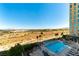 Resort-style pool and lounging area with palm trees and cityscape views, perfect for relaxation at 9101 Alta Dr # 301, Las Vegas, NV 89145