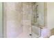 Inside the tile shower, there is a corner seat and shower head with various settings at 9101 Alta Dr # 301, Las Vegas, NV 89145