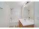 Bright bathroom featuring a shower over tub, a sink and a large mirror at 9507 Brewing Cloud Ave, Las Vegas, NV 89148
