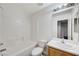 Bright bathroom featuring a tub/shower combo with tiled walls and a wood vanity at 9507 Brewing Cloud Ave, Las Vegas, NV 89148