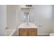 This bathroom features a white tub/shower combo and wood vanity at 9507 Brewing Cloud Ave, Las Vegas, NV 89148