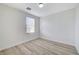This bedroom features wood-look floors and natural light from the window at 9507 Brewing Cloud Ave, Las Vegas, NV 89148