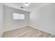 This bedroom features wood-look floors and natural light from the window at 9507 Brewing Cloud Ave, Las Vegas, NV 89148