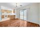 Open concept dining area next to kitchen, with hardwood floors and modern lighting at 9507 Brewing Cloud Ave, Las Vegas, NV 89148