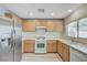 Efficient kitchen featuring stainless steel appliances, wood cabinets, and neutral countertop at 9507 Brewing Cloud Ave, Las Vegas, NV 89148