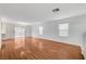 Bright and airy living room with hardwood floors and sliding glass doors that bring in ample light at 9507 Brewing Cloud Ave, Las Vegas, NV 89148