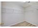 Bright walk-in closet features shelving and light wood-look floors at 9507 Brewing Cloud Ave, Las Vegas, NV 89148