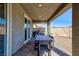 A spacious, covered patio perfect for outdoor dining featuring a dining table, grill, and plenty of space at 10095 Ferton Lake Ave, Las Vegas, NV 89178