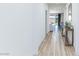 Hallway with modern flooring, leading to an open living area and outdoor view at 10095 Ferton Lake Ave, Las Vegas, NV 89178