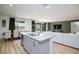 Modern kitchen with a granite island, a breakfast bar, and seamlessly connected to the living and dining spaces at 10095 Ferton Lake Ave, Las Vegas, NV 89178