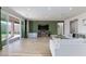 Spacious living area with sliding glass doors, a comfortable sofa, and a sleek entertainment center at 10095 Ferton Lake Ave, Las Vegas, NV 89178