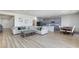 Open-concept living room with wood-look floors, a cozy sofa, and an adjacent dining area and kitchen at 10095 Ferton Lake Ave, Las Vegas, NV 89178