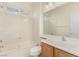 This bathroom features a shower-tub combo, a single sink vanity, and tile flooring at 10463 Luna Magico Ave, Las Vegas, NV 89135